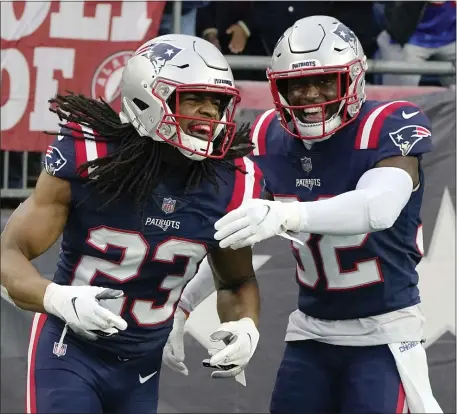  ?? STEVEN SENNE — THE ASSOCIATED PRESS ?? Patriots safety Kyle Dugger (23), shown celebratin­g with Devin McCourty during a Jan. 2, 2022 game, was limited at practice Wednesday.