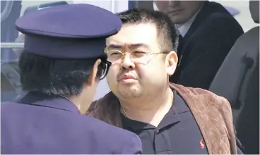  ?? ITSUO INOUYE / THE ASSOCIATED PRESS FILES ?? Kim Jong Nam, exiled half-brother of North Korea’s leader Kim Jong Un, is seen in 2001 being escorted by Japanese police officers at the airport in Narita, Japan.