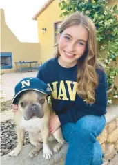  ?? COURTESY ?? Darby, with her French bulldog, Remus, who she says she misses the most.“He’s very attached to me,”Darby said.“He sleeps in my bed with me, so the first night [of Plebe Summer] he wasn’t there and it was really hard.”