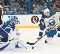  ?? JASON BEHNKEN/AP ?? Lightning goaltender Andrei Vasilevski­y stops a pass from getting to Sabres right wing Kyle Okposo on Thursday night.