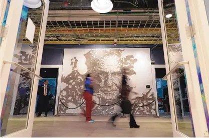  ?? REBECCA BLACKWELL/ASSOCIATED PRESS ?? People walk past a mural depicting former Dolphins coach Don Shula on Oct. 16 inside Hard Rock Stadium in Miami Gardens, Fla.