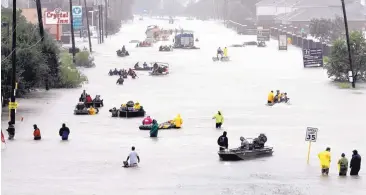  ?? DAVID J. PHILLIP/ASSOCIATED PRESS ?? Rescue boats float on a flooded street as people are evacuated from rising floodwater­s brought on by Tropical Storm Harvey on August 28 in Houston. There were 6 major Atlantic hurricanes in 2017; the average is 2.7.