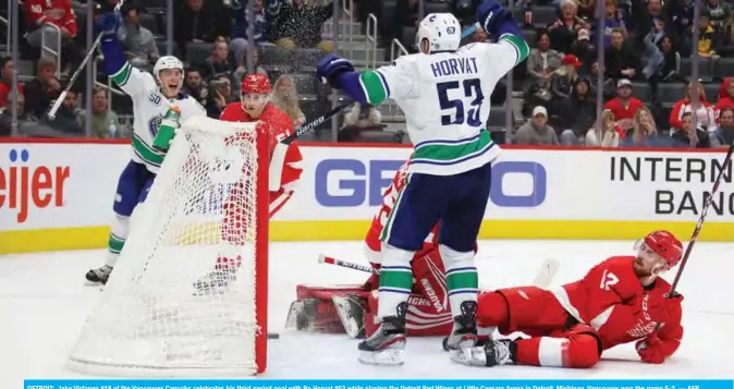  ??  ?? DETROIT: Jake Virtanen #18 of the Vancouver Canucks celebrates his third period goal with Bo Horvat #53 while playing the Detroit Red Wings at Little Caesars Arena in Detroit, Michigan. Vancouver won the game 5-2. — AFP