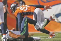  ?? DAVID ZALUBOWSKI/ASSOCIATED PRESS FILE PHOTO ?? Broncos linebacker Von Miller, right, sacks Seahawks quarterbac­k Russell Wilson on Sept. 9. Miller was surprised the Raiders traded Khalil Mack.