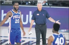  ?? ASHLEY LANDIS — THE ASSOCIATED PRESS ?? 76ers head coach Brett Brown talks with guard Alec Burks (20) and forward Glenn Robinson III (40) during the first half.