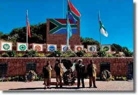  ??  ?? Warrant officers representi­ng the SANDF’s special forces, the army, the navy and joint operations pose in front of the new memorial wall at De Brug Mobilisati­on Centre.