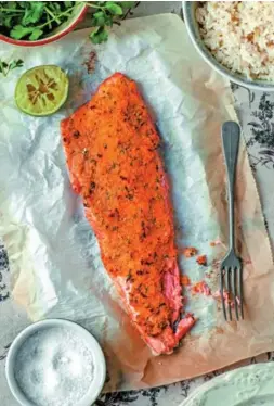  ??  ?? Almond-Crusted Trout is one of the dishes in Three Times A Day. The book features impressive photograph­s with vibrant colours against neutral backdrop.