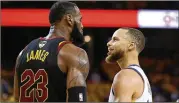  ?? EZRA SHAW / GETTY IMAGES ?? LeBron James and Stephen Curry exchange words during overtime of Game 1 on Thursday night between Cleveland and Golden State.