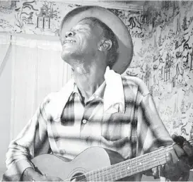  ?? Houston Chronicle file ?? Blues legend “Lightnin’” Hopkins, shown in 1959, began his musical career at age 8, when he made a guitar by cutting a hole in a cigar box, nailing on a plank of wood and stringing it with wire. He lived many years in Houston’s ThirdWard.