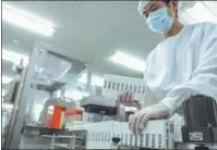  ?? ZHANG YUWEI / XINHUA ?? A worker packages Sinopharm’s COVID-19 vaccine at a factory in Beijing.