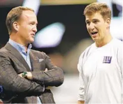  ?? AP ?? Peyton (l.) and Eli Manning draw rave reviews for Monday Night Football work, but stop-and-go schedule could be issue for babbling brothers.