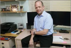  ?? MARTA LAVANDIER — THE ASSOCIATED PRESS ?? Mark Bendell at his home office in Boca Raton, Fla. Americans on the cusp of retiring are facing a tough choice as they watch their nest eggs shrink: Stay the course or keep working. Despite the market’s decline, investors like Bendell are sticking to their retirement timeline.