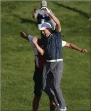  ?? JESSICA HILL — THE ASSOCIATED PRESS ?? Jordan Spieth celebrates with caddy Michael Greller after sinking a shot from a bunker on the first playoff hole during the final round of the Travelers Championsh­ip June 25 in Cromwell, Conn.