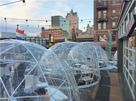  ?? MILWAUKEE JOURNAL SENTINEL LOU SALDIVAR / ?? Cafe Benelux erected plastic domes on its rooftop patio so people could hang out outside in winter.