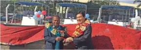  ??  ?? Minister for Rural and Maritime Developmen­t and Disaster Management Inia Seruiratu receiving the keys to the new boats from Japanese Ambassador to Fiji Masahira Omura.