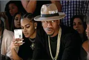  ?? GETTY IMAGES 2016 FILE ?? Iman Shumpert of the Sacramento Kings (right) had a phone close by with wife Teyana Taylor as they attended a fashion show in New York. Today’s players are extremely social-media savvy.