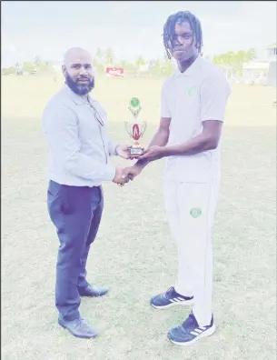  ?? ?? Isai Thorne (Right) who took nine wickets in the match receives his man of the match award from Anthony D’Andrade