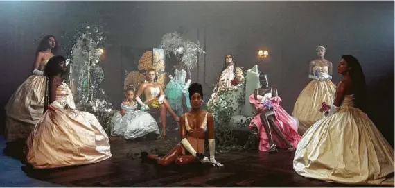 ?? Parkwood Entertainm­ent / Disney+ ?? Kelly Rowland, center, appears with Beyoncé and her daughter Blue Ivy Carter, seated background left, in “Brown Skin Girl,” a scene from Beyoncé’s visual album “Black Is King.”