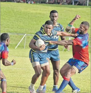  ?? Picture: BALJEET SINGH ?? Ifireimi Tovilevu, with ball, attacks for Vusu Raiders against Vatukoro Titans during their semi-final clash in the Nadroga-Navosa 9s tournament at Prince Charles Park in Nadi.