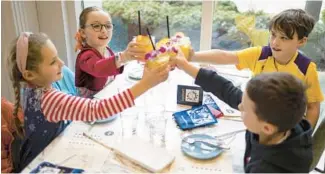  ?? ?? Mollie Illuzzi, 8, clockwise from left, Morgan Illuzzi, 9, Paul Weltman, 10, and Sam Weltman, 6, raise their mocktails for a toast Sunday at Little Diner’s Crew.