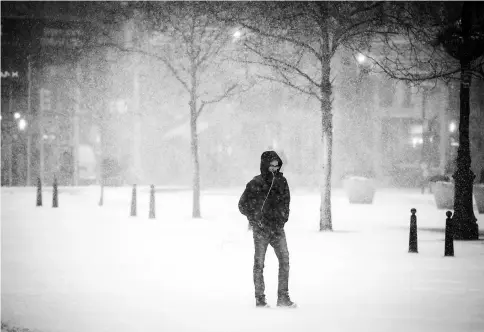  ??  ?? A pedestrian walks through Union Square during a snow storm in New York on Jan 4. — WP-Bloomberg photo