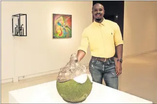  ?? A large, rough-surfaced, round ceramic vase or jug, has won the top cash prize in a student show at the University of Oklahoma. Simphiwe Mbunyuza won the $1,000 Oscar Jacobson Award for the work, based on the culture of the Xhosa people in South Africa wh ?? Simphiwe Mbunyuza won the $1,000 Oscar Jacobson Award in the University of Oklahoma School of Visual Arts exhibition for work based on his native people in South Africa.