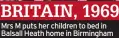  ?? ?? BRITAIN, 1969 Mrs M puts her children to bed in Balsall Heath home in Birmingham