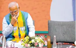  ?? AP ?? Indian Prime Minister Narendra Modi listens to Bharatiya Janata Party (BJP) President JP Nadda speak during an event organised to release their party’s manifesto for the national parliament­ary elections in New Delhi, India.