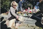  ?? Myung J. Chun Los Angeles Times ?? B R I NA Baird-Gerber pets Zoie, a dog brought in to comfort mourners of the Thousand Oaks shooting.