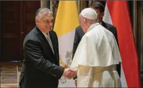  ?? Museum of Fine arts. (ap/Vatican Media ) ?? Pope Francis shakes hands with Hungarian prime Minister Viktor orban on Sunday at budapest’s