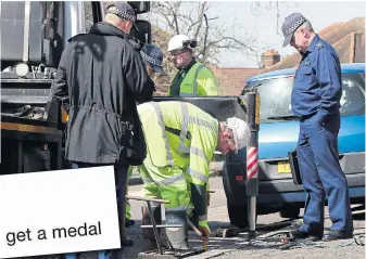  ??  ?? Police checking drains outside the house in south-east London yesterday for clues