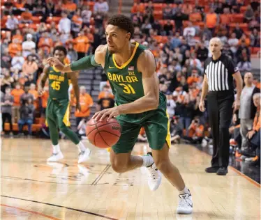  ?? Brody Schmidt/Associated Press ?? ■ Baylor guard MaCio Teague (31) drives the ball during the second half of a college basketball game against Saturday Oklahoma State in Stillwater, Okla.