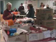  ?? PHOTO PROVIDED ?? Volunteers help prepare donations for families at Hope 7 Food Pantry.
