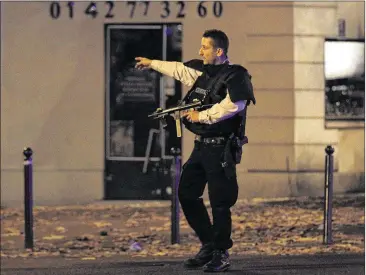  ?? THIERRY CHESNOT / GETTY IMAGES ?? Police survey the area of Boulevard Baumarchai­s following an attack in the French capital on Friday, one of several in the city. There was no immediate claim of responsibi­lity for the wave of attacks, but Twitter erupted with celebrator­y messages by...