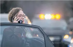  ?? AFP ?? A woman speaks on the phone near the Congregati­on Beth Israel synagogue on Saturday in Colleyvill­e, Texas.