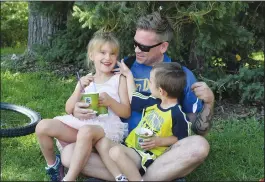  ?? NEWS PHOTO MO CRANKER ?? Dave, Jack and Holly Mulligan enjoy some some slushies Saturday at Strathcona Park after biking to the park as part of the Great Big Trail event. The event was the first of its kind in Medicine Hat and was held to celebrate Canada, and Medicine Hat's...