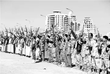  ?? — Reuters photo ?? Armed Houthi followers raise their rifles as they attend a gathering to show support for the Houthi movement in Sanaa,Yemen.