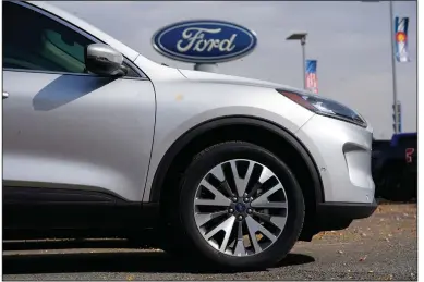  ?? (AP) ?? A 2020 Ford Escape SUV sits at a dealership in Denver in this file photo. Ford said its Louisville Assembly Plant in Kentucky, which builds the Escape along with the Lincoln Corsair, will be idled this week because of the semiconduc­tor shortage.