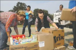  ?? BEA AHBECK/NEWS-SENTINEL ?? Jessie’s Grove’s general manager Lisa Brand, wine club coordinato­r Tami Gampp, wine team manager Sarah Williams and Grace and Mercy volunteer Jimmy Geralisas stack donations from Grace and Mercy at Jessie’s Grove as Lodians donate food and other items...