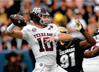  ?? David Zalubowski / Associated Press ?? Texas A&M sophomore quarterbac­k Zach Calzada completed less than half of his passes in the Aggies’ win over Colorado, but he engineered a game-winning drive that ended with a touchdown pass to Isaiah Spiller, averting the upset in Boulder.