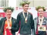  ??  ?? R IGHT From left to right, Dylan Wykes, Reid Coolsaet and Eric Gillis sharing the Canadian podium at the 2011 Toronto Waterfront Marathon