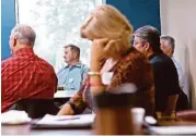  ?? Elizabeth Conley / Houston Chronicle ?? Shaun Conley, center, who lost his job with Baker Hughes, attends Between Jobs Ministry in Spring.