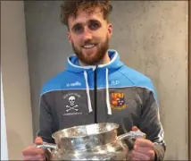  ??  ?? Ross Donohoe getting acquainted with the Fitzgibbon Cup.