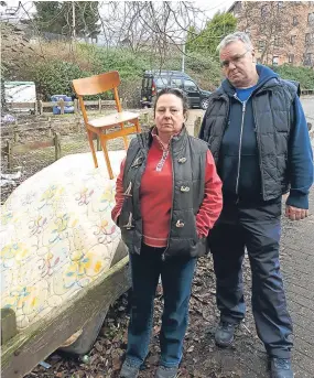  ??  ?? Doris Walker and Andy O’Neill with the rubbish which has been dumped.