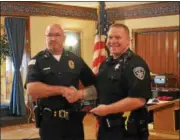  ?? PHOTOS BY JOHN BREWER — ONEIDA DAILY DISPATCH ?? Canastota Police Chief James Zophy congratula­tes former CPD member Kenneth Gates.