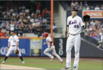  ?? FRANK FRANKLIN II — THE ASSOCIATED PRESS ?? Scott Kingery, center, rounds first after the ball he hit off Mets starting pitcher Jacob deGrom, right, had exited Citi Field Friday night in New York.