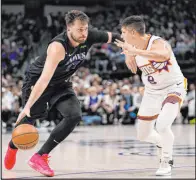  ?? Tony Gutierrez The Associated Press ?? Mavericks guard Luka Doncic attempts to get past Suns guard Grayson Allen during Dallas’ victory Thursday at American Airlines Center.