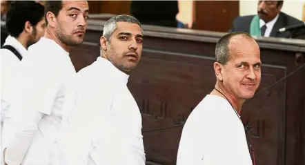  ?? — EPA ?? Losing their freedom: Greste (right) with Fahmy and Mahmoud in front of the judge’s bench during their trial for allegedly supporting a terrorist group and spreading false informatio­n.