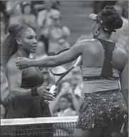  ?? CHRIS TROTMAN/GETTY ?? Serena Williams and sister Venus Williams meet at the net.