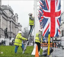  ?? NEIL HALL / EFE ?? Londres. Varios operarios levantan banderas de la Unión para el gran día.